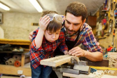 Father and son woodworking in shop
